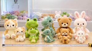 Different sizes of crane machine plush toys displayed with a measuring tape